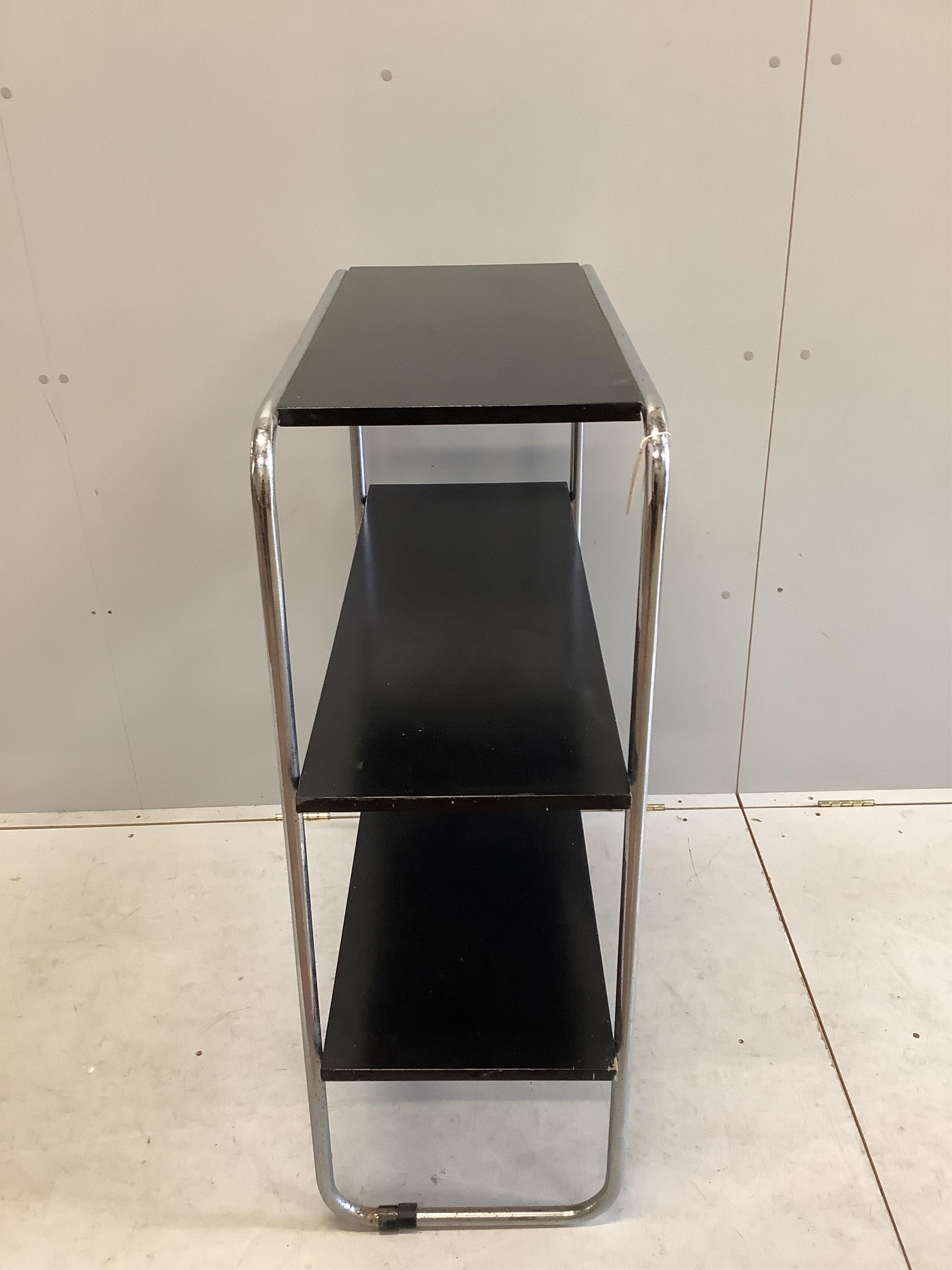 A mid century black lacquer and chrome three tier shelf unit, width 93cm, depth 38cm, height 107cm. Condition - poor to fair